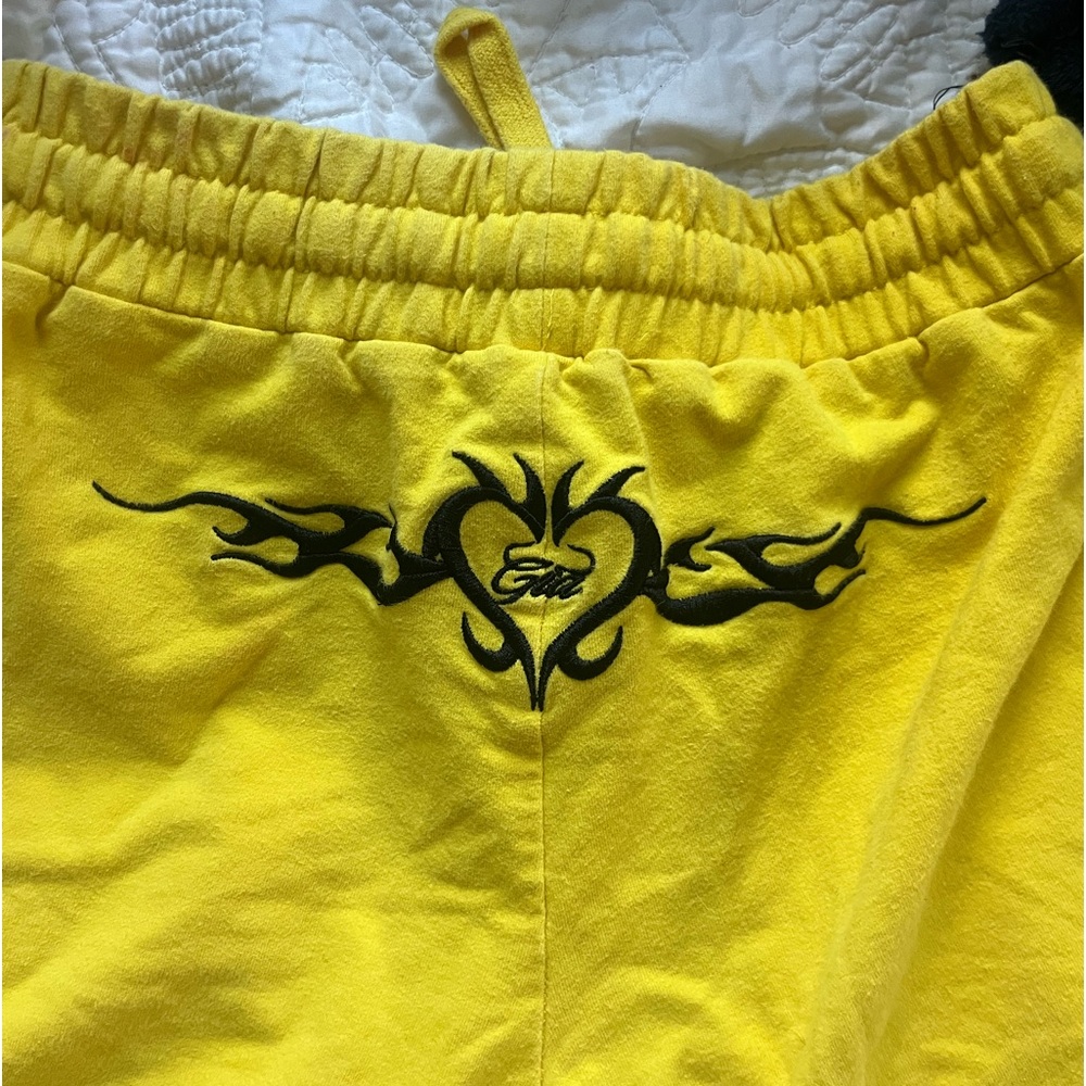 I.Am.Gia yellow flare pants with tramp stamp design